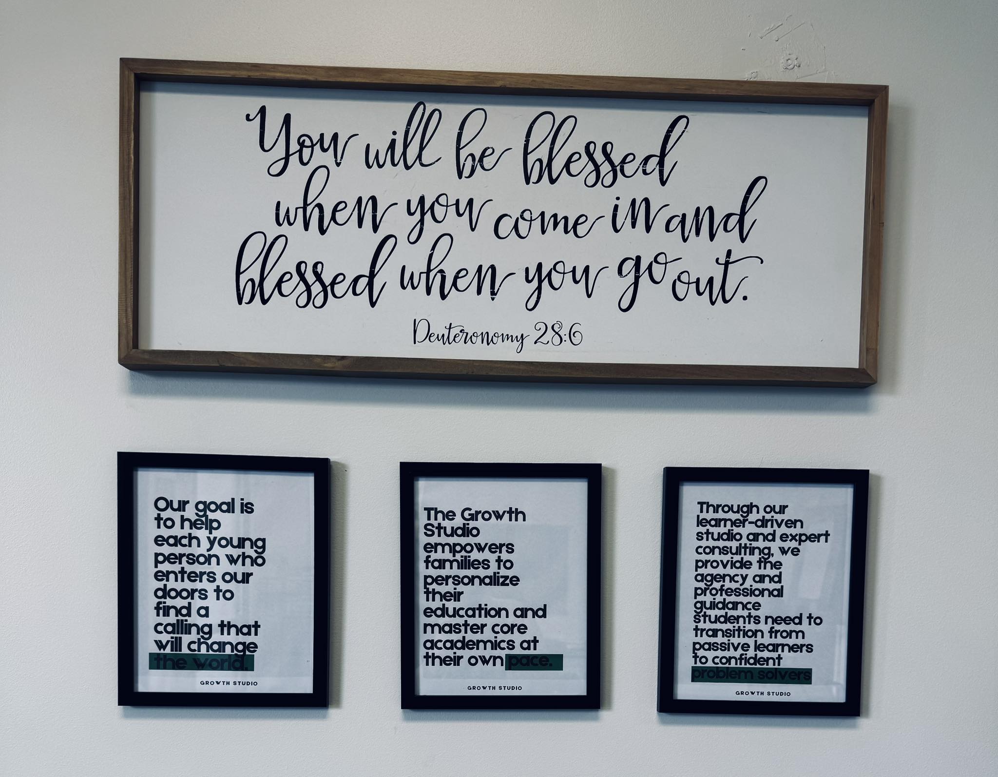Wall at Growth Studio with Deuteronomy 28:6 and the three mission statements